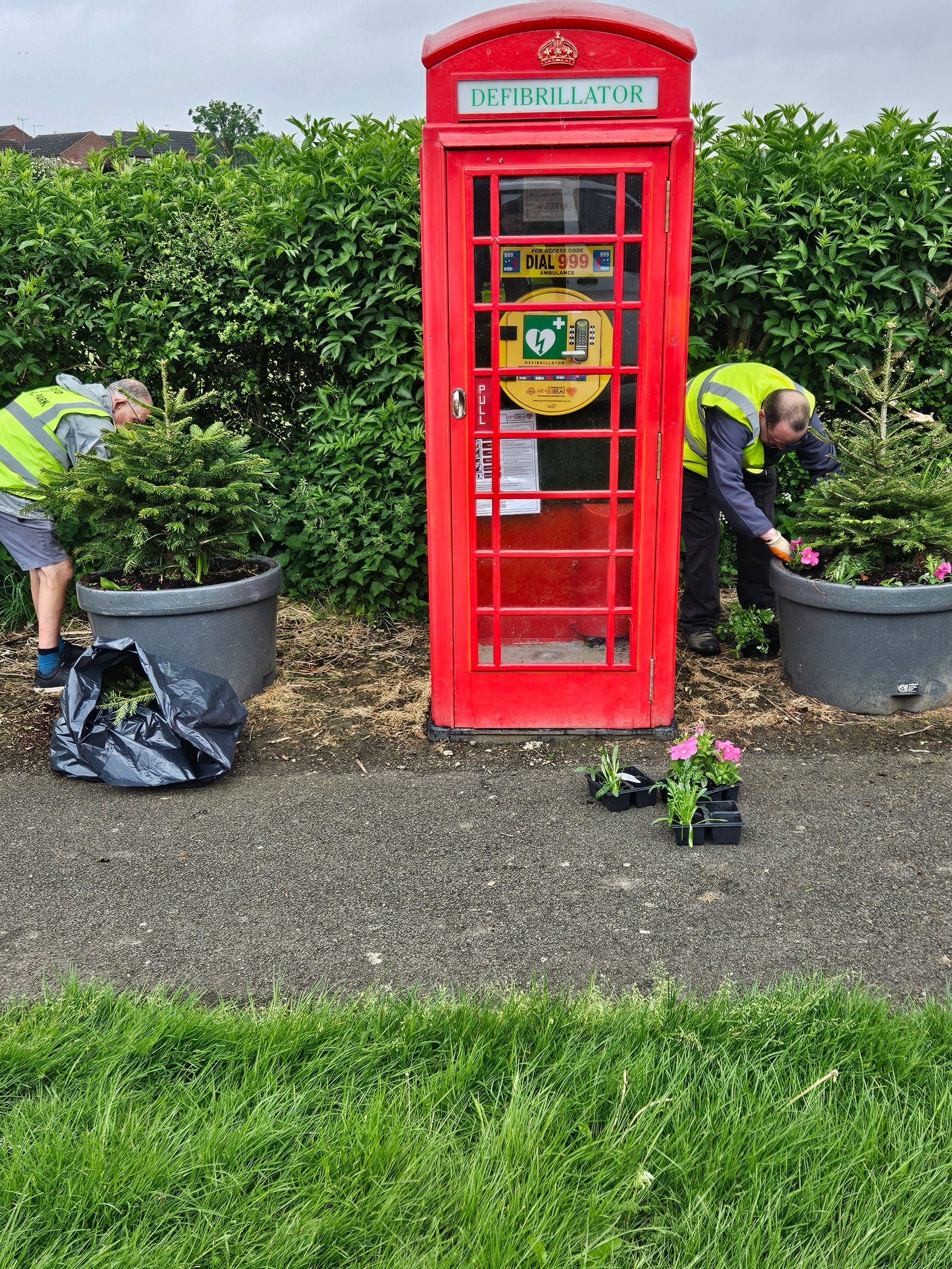 Cllr Ian Newham and Parish Ranger Martin adding summer planting to the tree planters