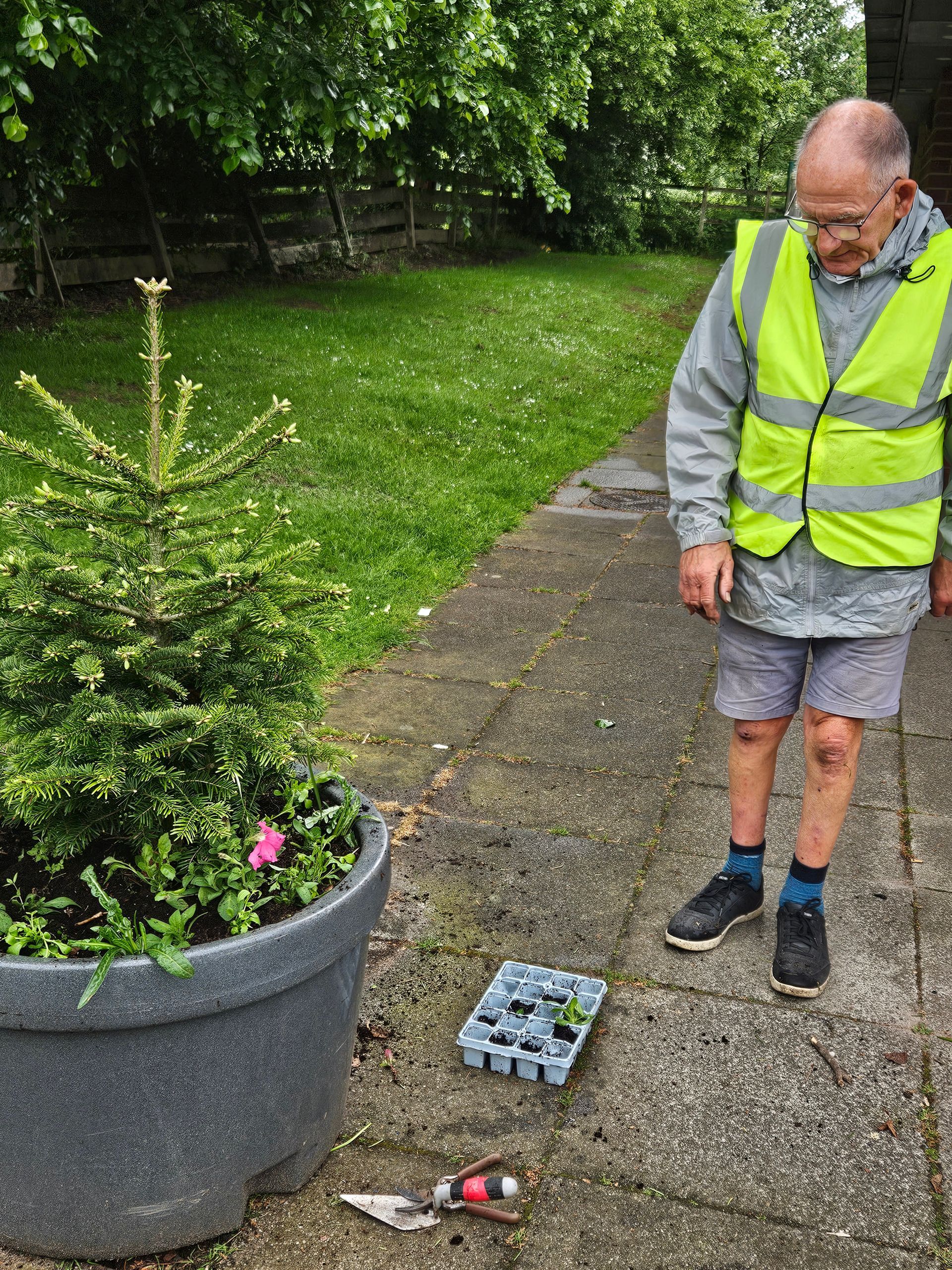 Cllr Ian Newham preparing to plant in the tree planters