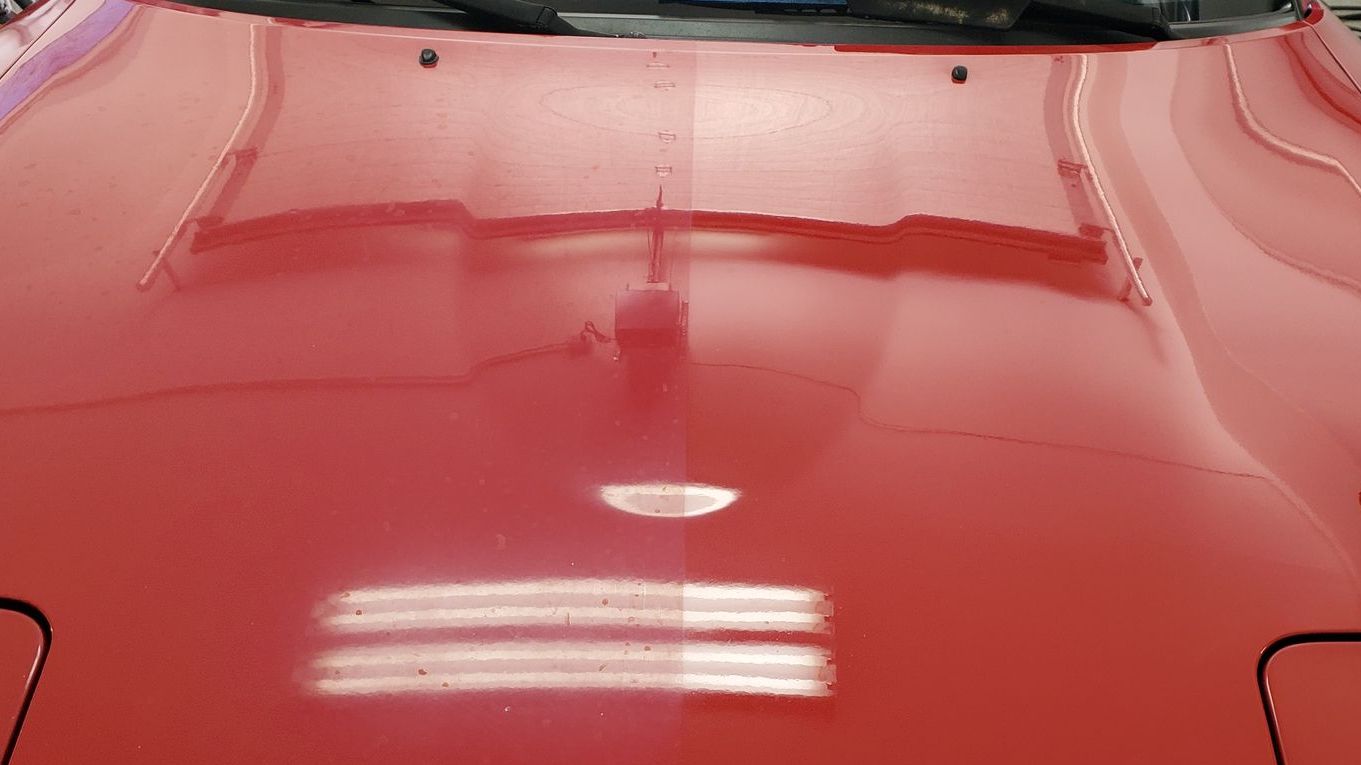 Red Miata with half hood oxidized from sun light