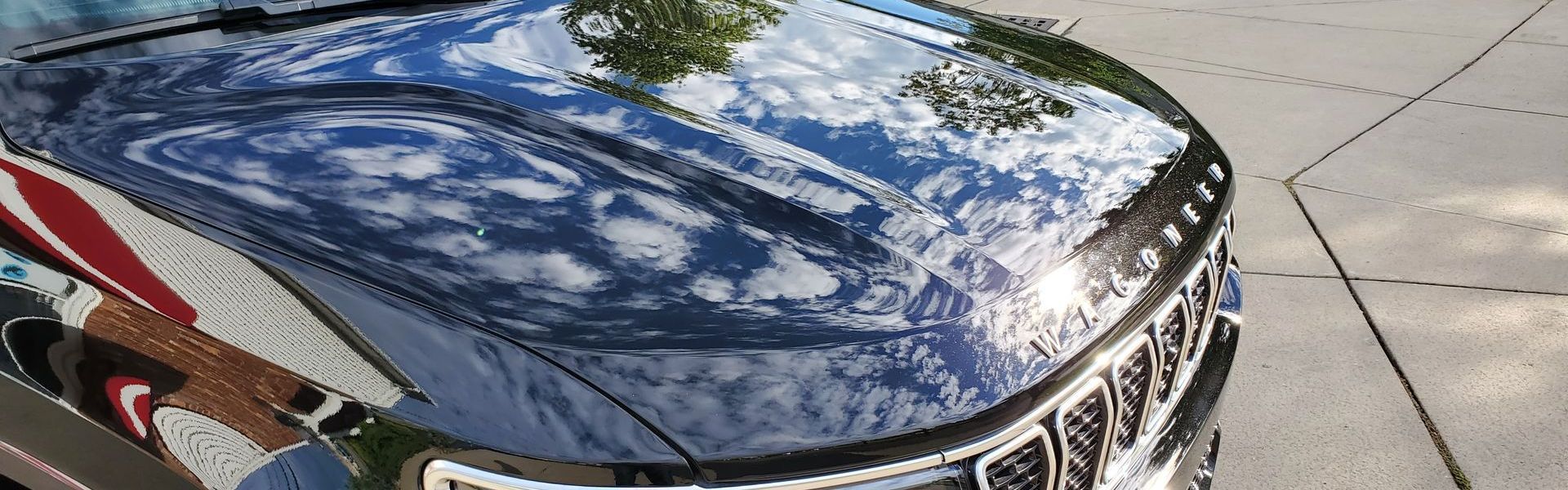 Beautiful reflect of sun and clouds on vehicle hood after ceramic coating