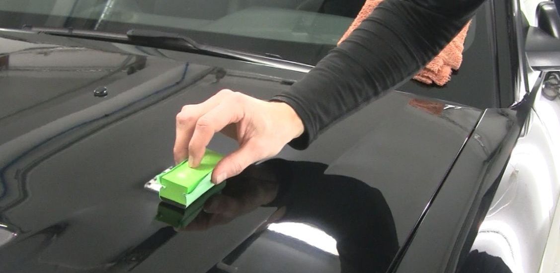 Ceramic coating being applied to vehicle