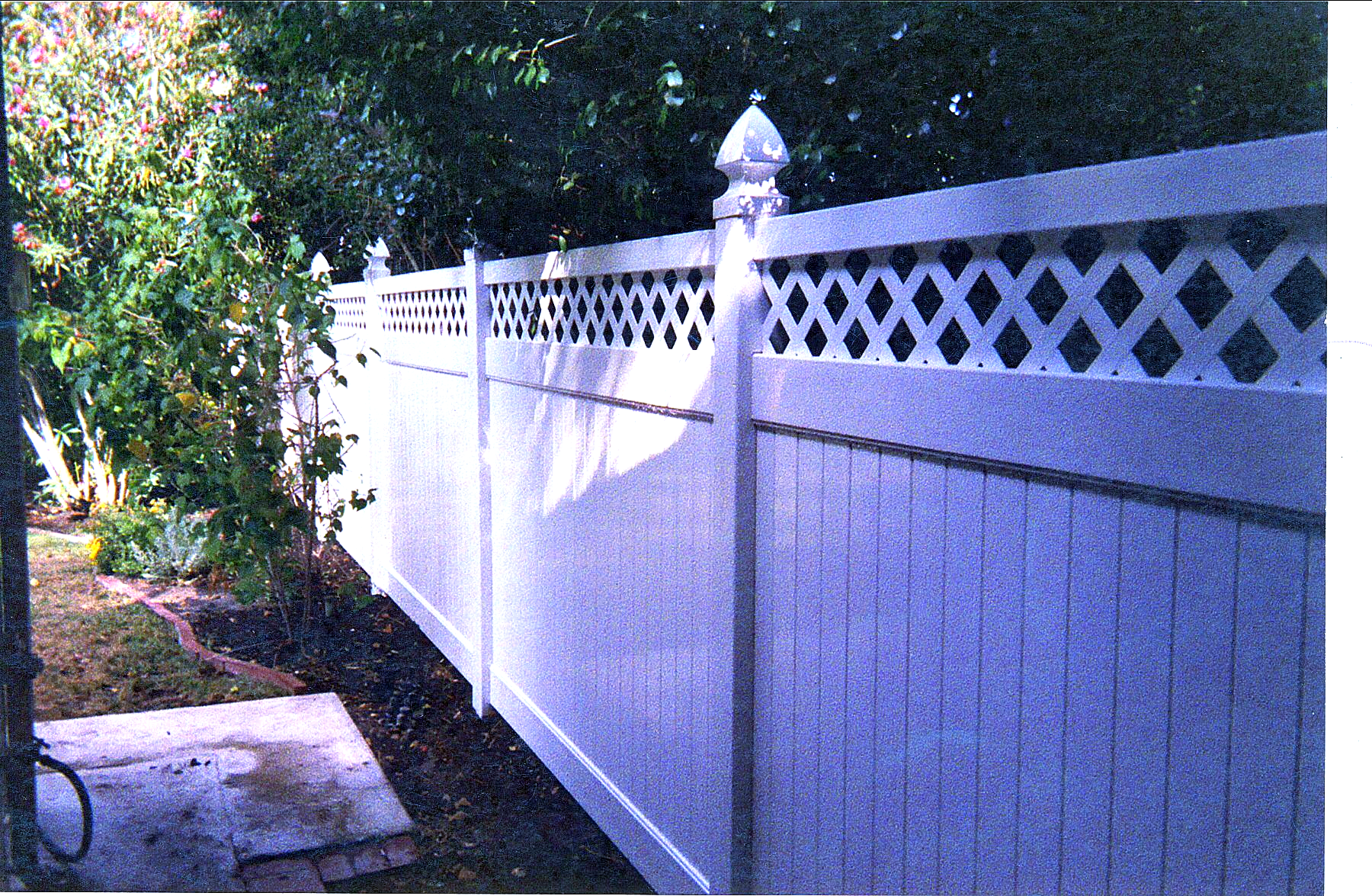 A white fence with a diamond pattern on it