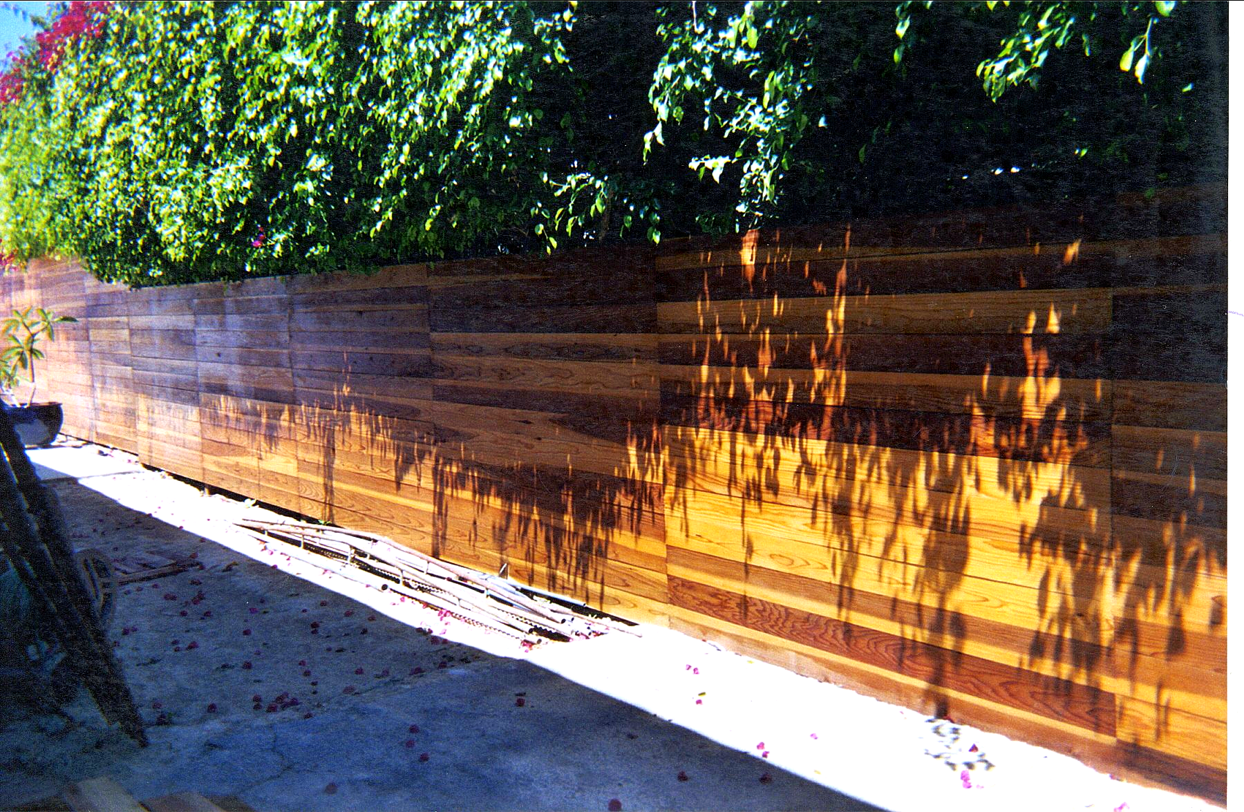 A picture of a wooden fence with trees in the background