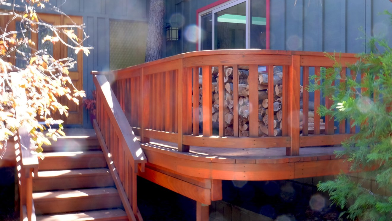 A wooden deck with stairs leading up to it