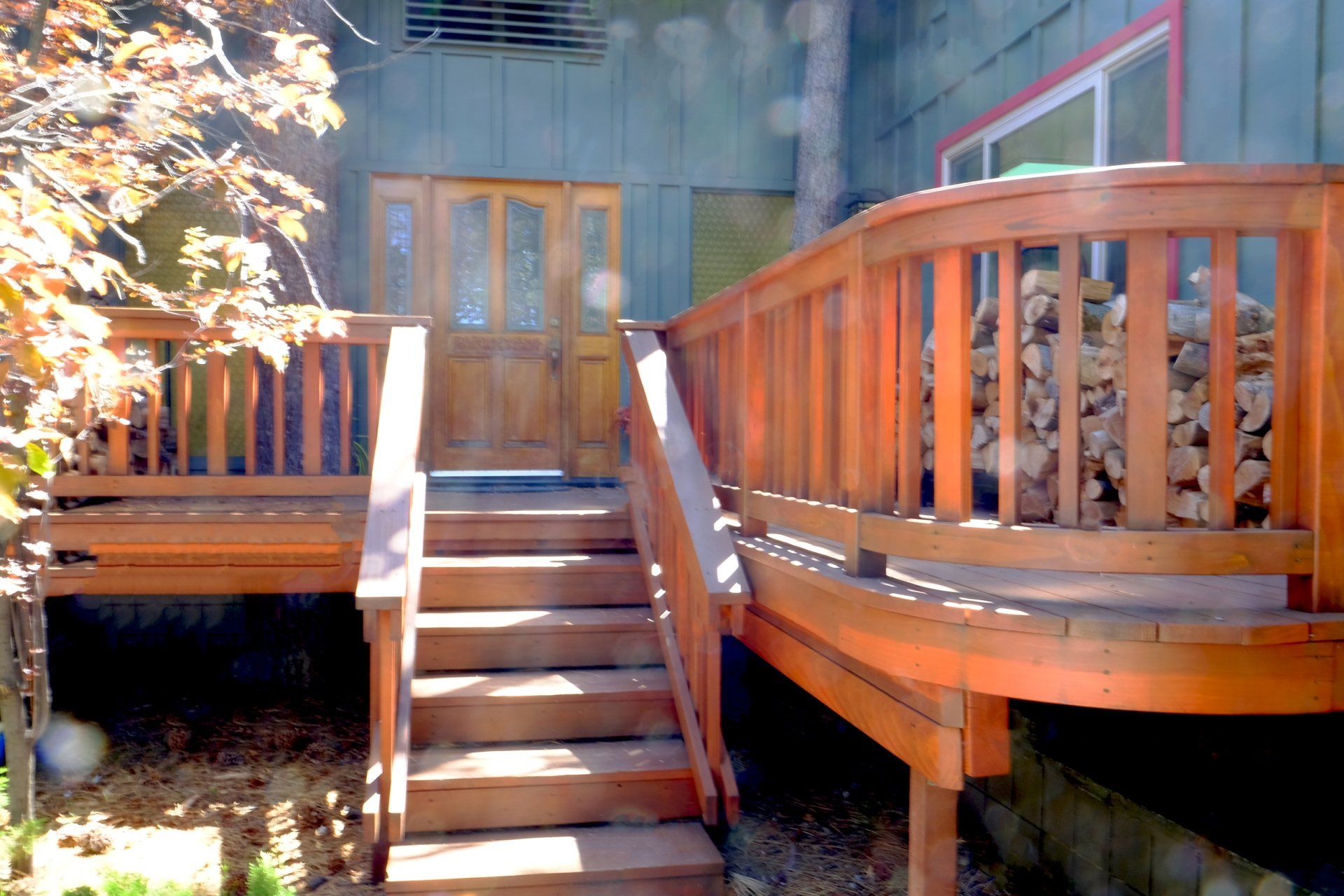 A wooden deck with stairs leading up to it