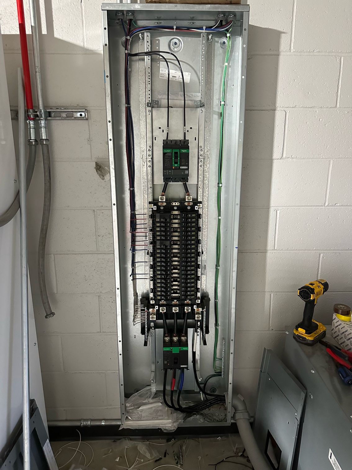 An electrical box mounted on a brick wall.