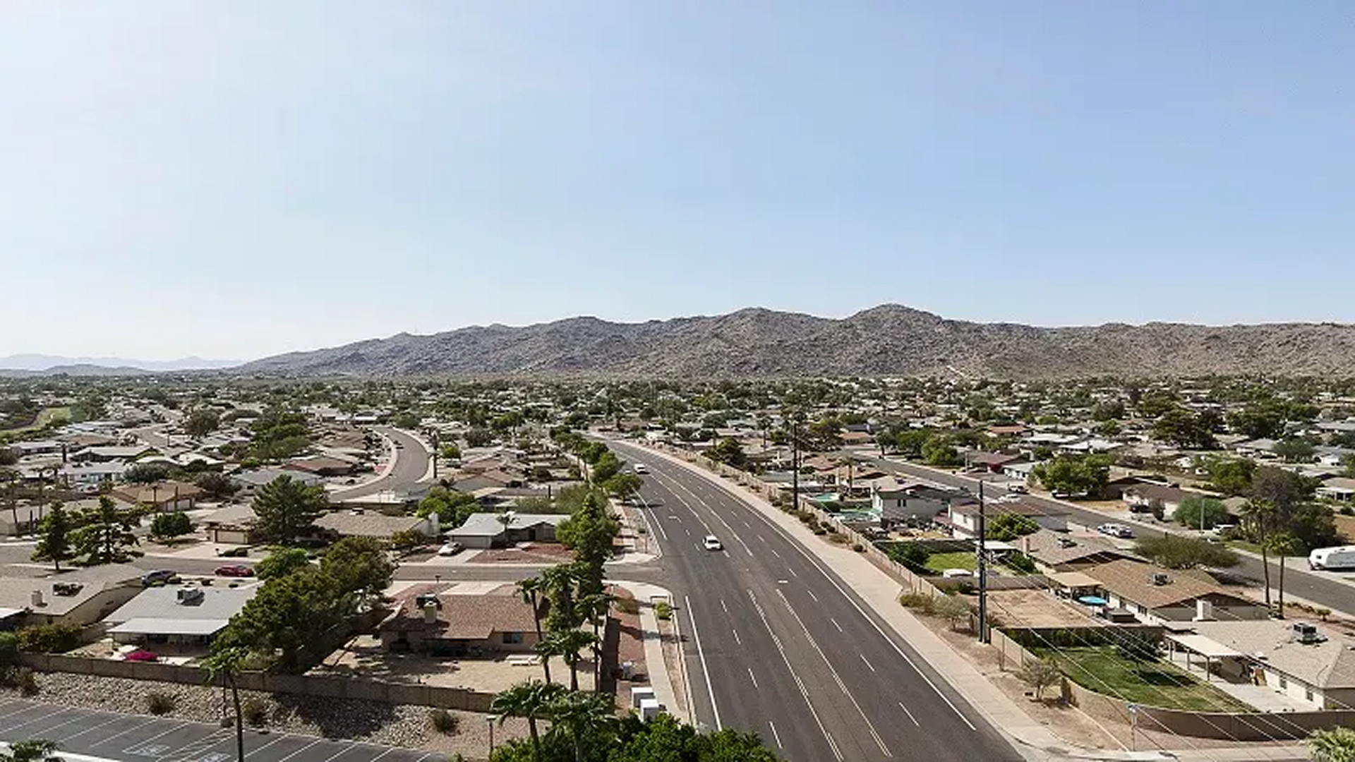 An aerial view of a residential area with a highway going through it