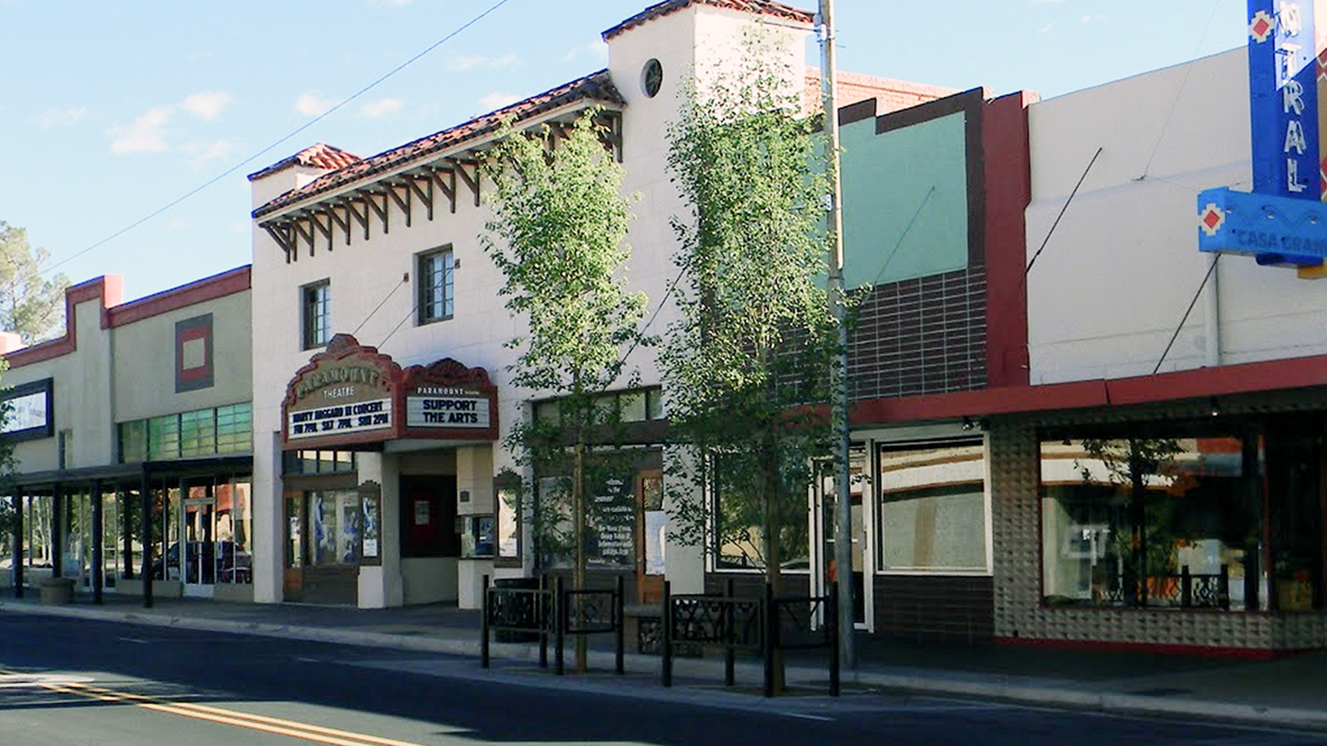 A row of stores on a city street including a domino 's