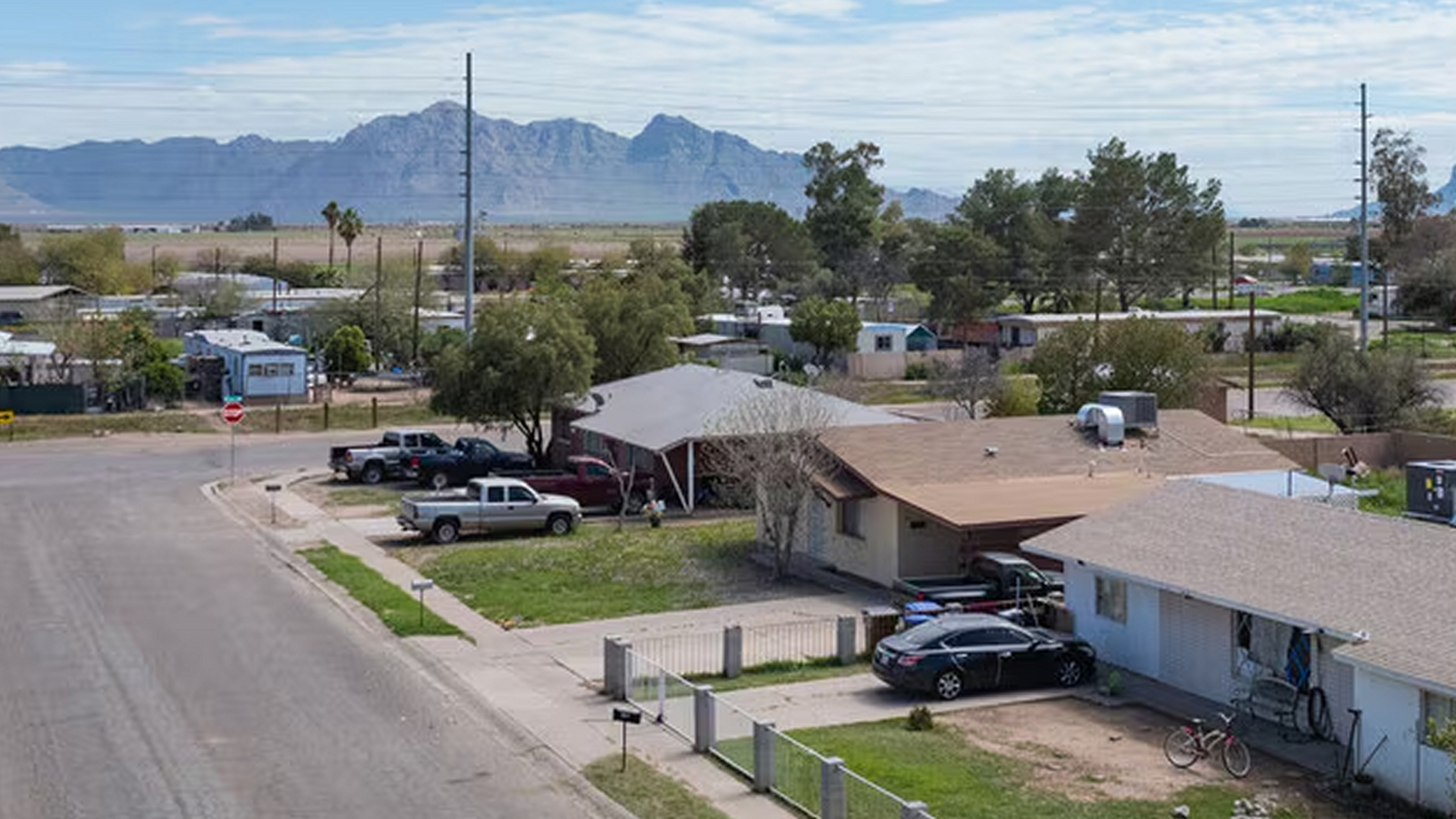 An aerial view of a residential neighborhood with mountains in the background.