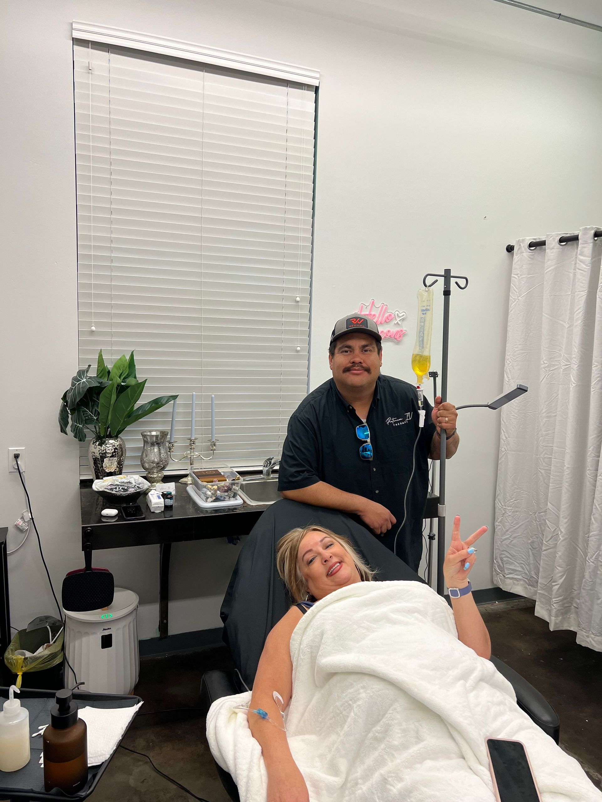 A woman is laying in a chair with an iv in her arm.