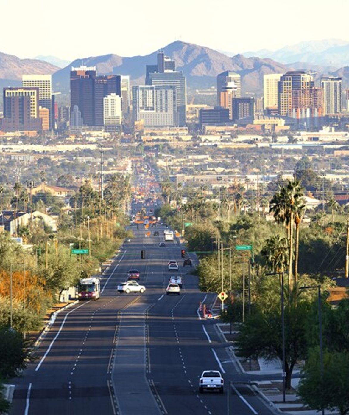 An aerial view of a city with a highway in the foreground