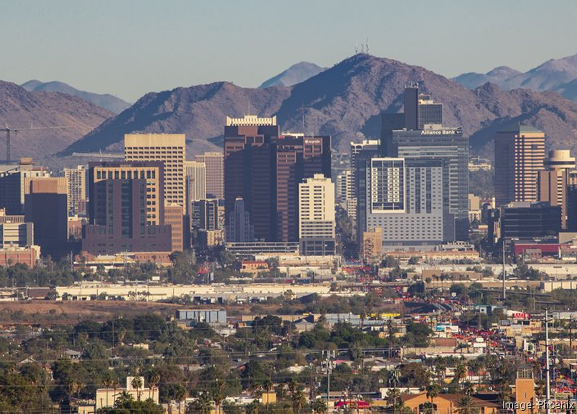 An aerial view of a city with mountains in the background