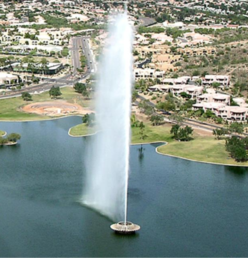 An aerial view of a fountain in the middle of a lake