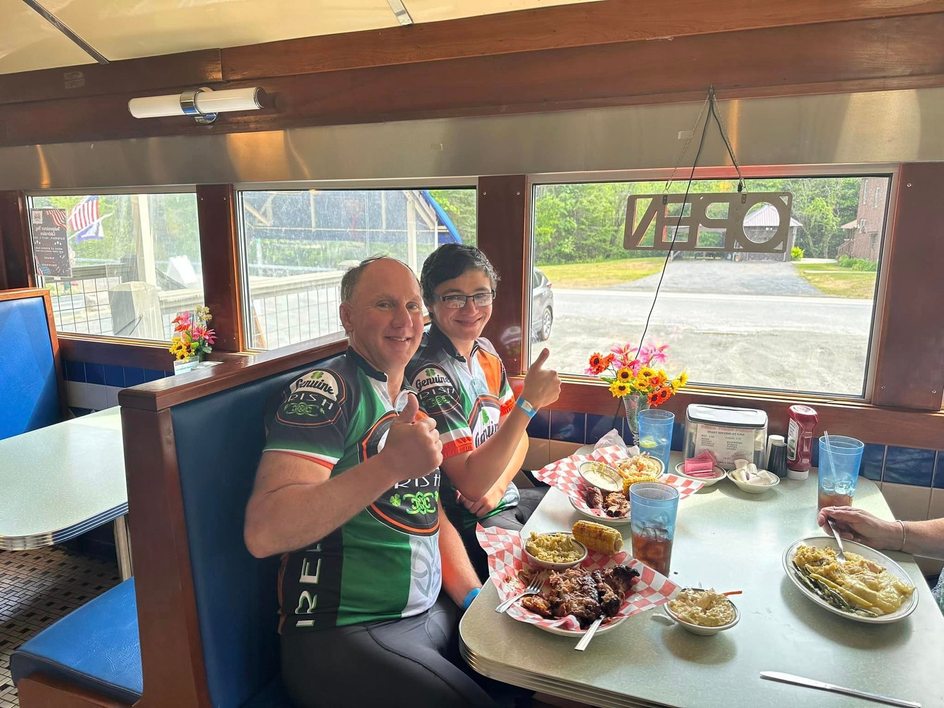 A man and a woman are sitting at a table in a diner.