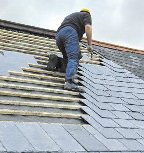A man working on slate roofing