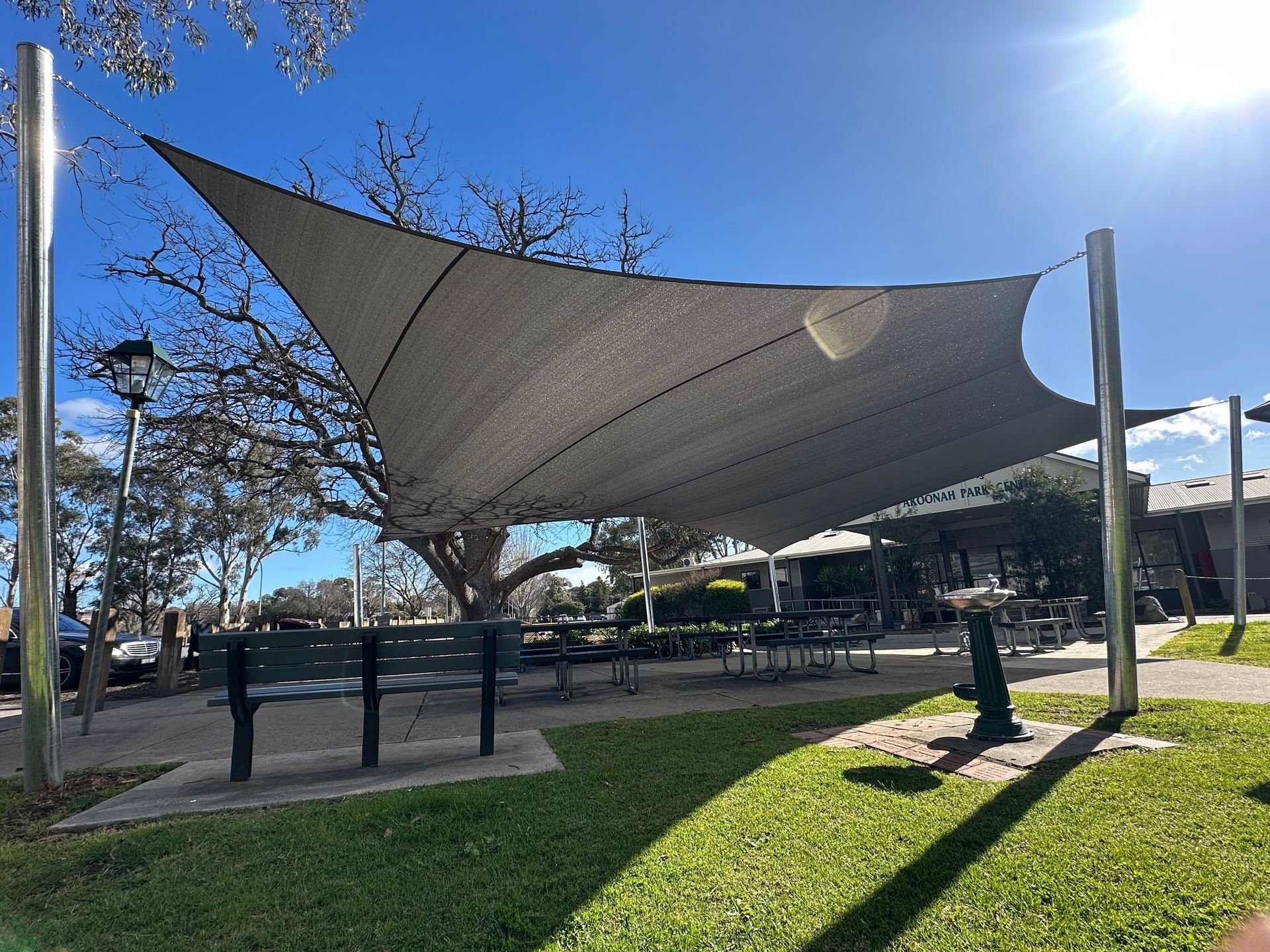 Akoonah Park Reserve improvement project in Victoria — installation of modern shade sail canopy, accessible seating, and updated park amenities to enhance visitor experience. protection from harsh UV rays 
