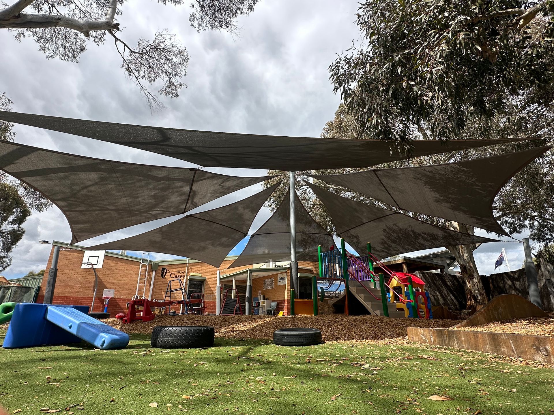 Large Commercial shade sail linked together over kindergarten playground for shade protection over soft fall area, located in Cranbourne and Clyde area