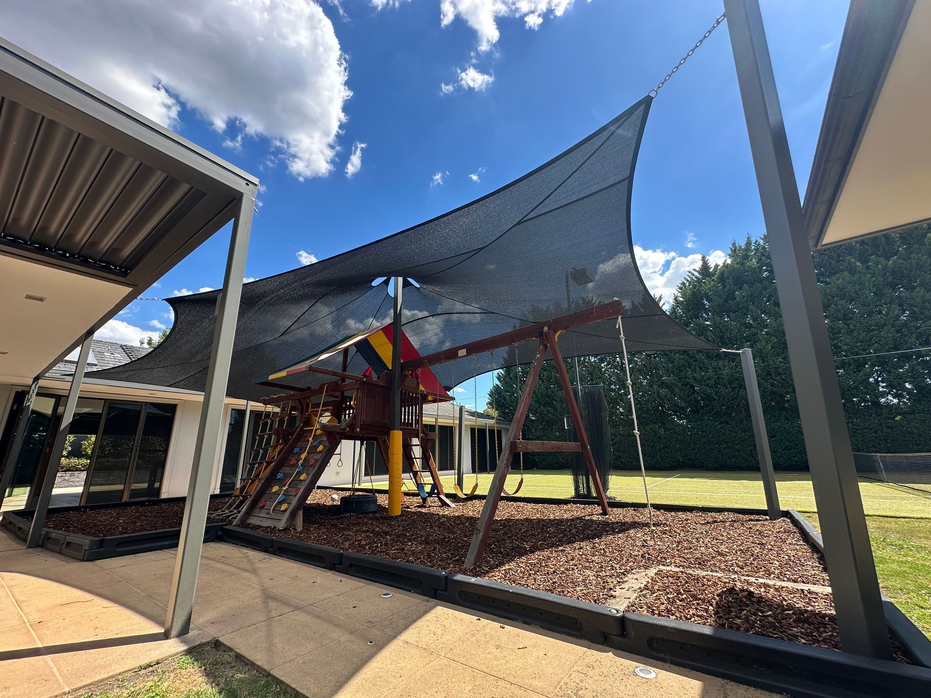 Premium shade sail installation over a backyard playground in Templestowe, featuring a durable, UV‑protective shade sail structure designed for residential outdoor areas
