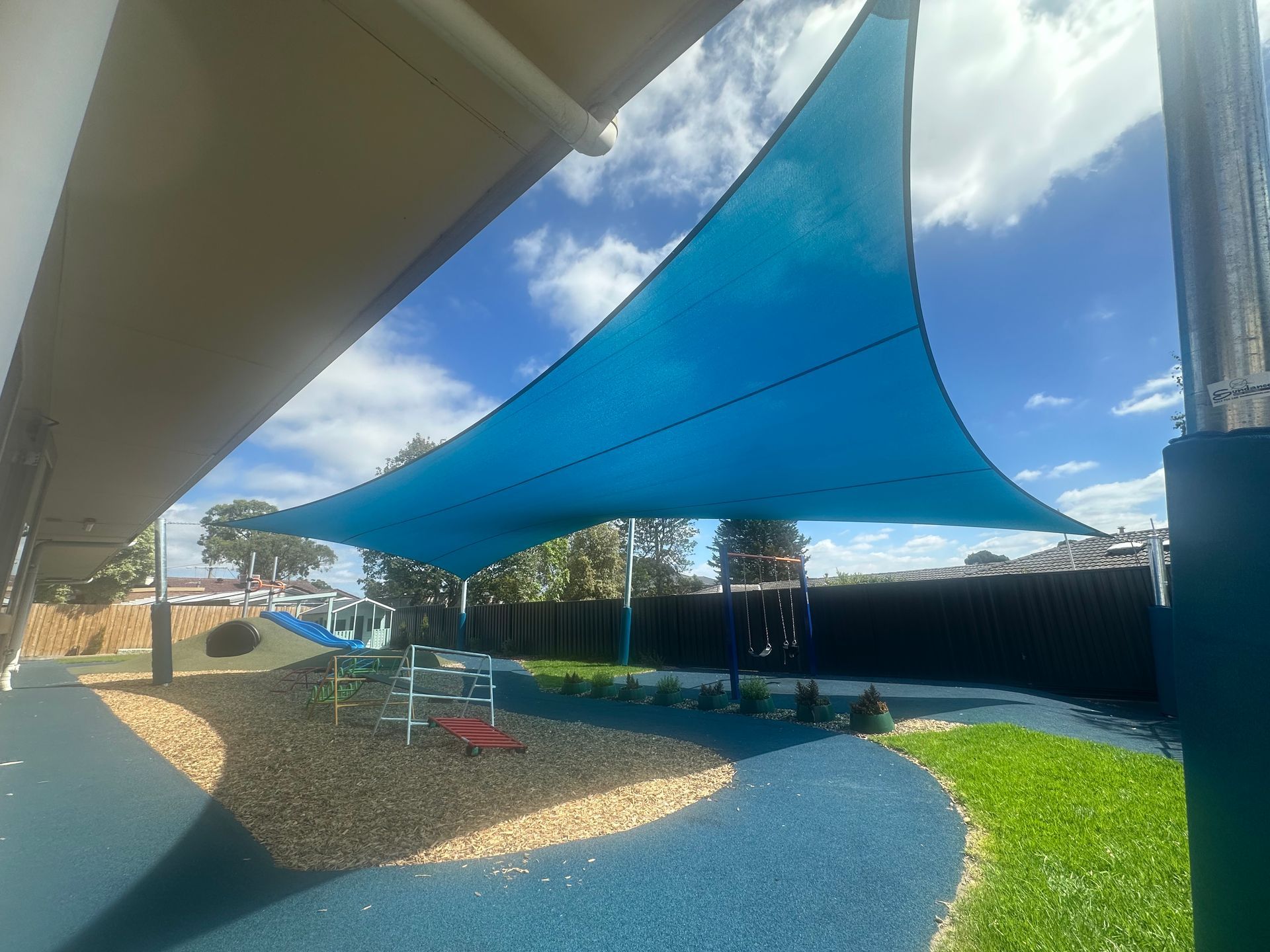 Commercial shade sail installation over a modern kindergarten and school playground in Clyde, designed and built by a licensed builder specialising in durable shade structures for new Melbourne suburbs, supporting construction companies, architects, and education facility projects.