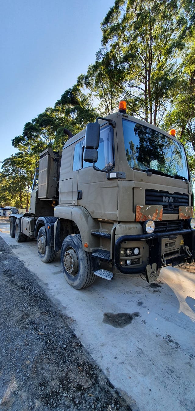 A Military Truck Is Parked On The Side Of The Road — B & W Commercials In Wauchope, NSW