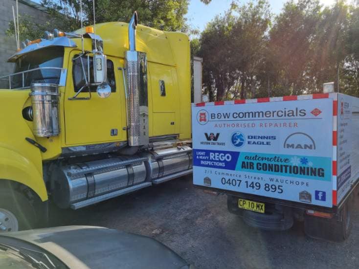 A Yellow Semi Truck With A Box On The Back That Says Saw Commercials — B & W Commercials In Wauchope, NSW