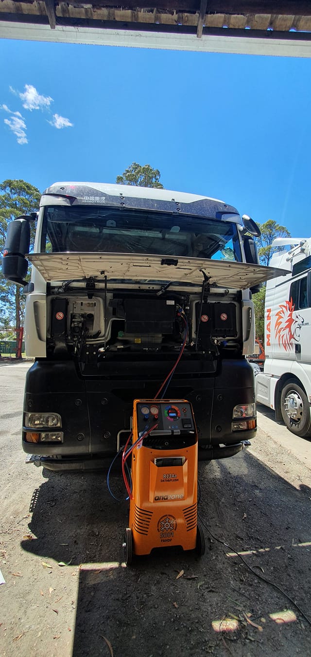 A Truck With Its Hood Up Is Being Worked On By A Mechanic — B & W Commercials In Wauchope, NSW