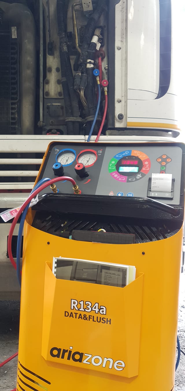 A Yellow Machine Is Sitting In Front Of A Truck — B & W Commercials In Wauchope, NSW
