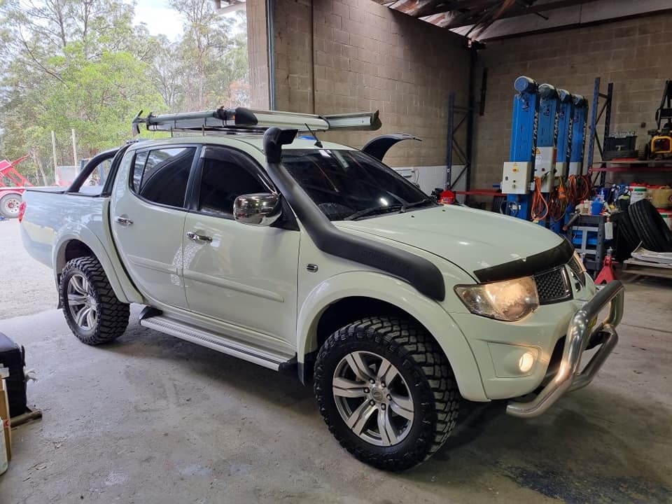A White Truck With A Snorkel On The Roof Is Parked In A Garage — B & W Commercials In Wauchope, NSW