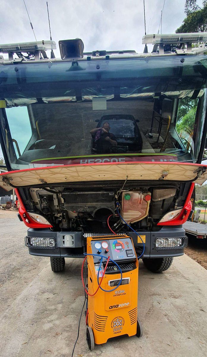 A Fire Truck With Its Hood Up Is Being Worked On — B & W Commercials In Wauchope, NSW