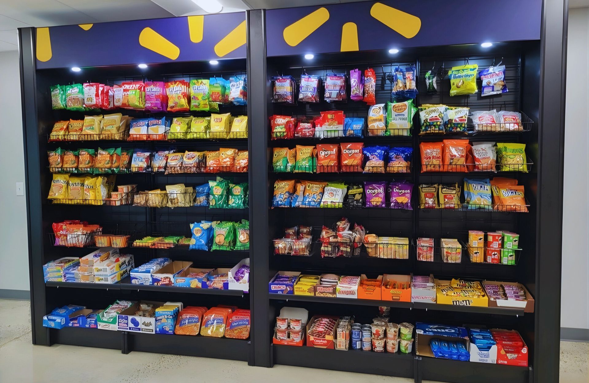 A Walmart snack display shelf stocked with various bags of chips, crackers, and packaged food items.