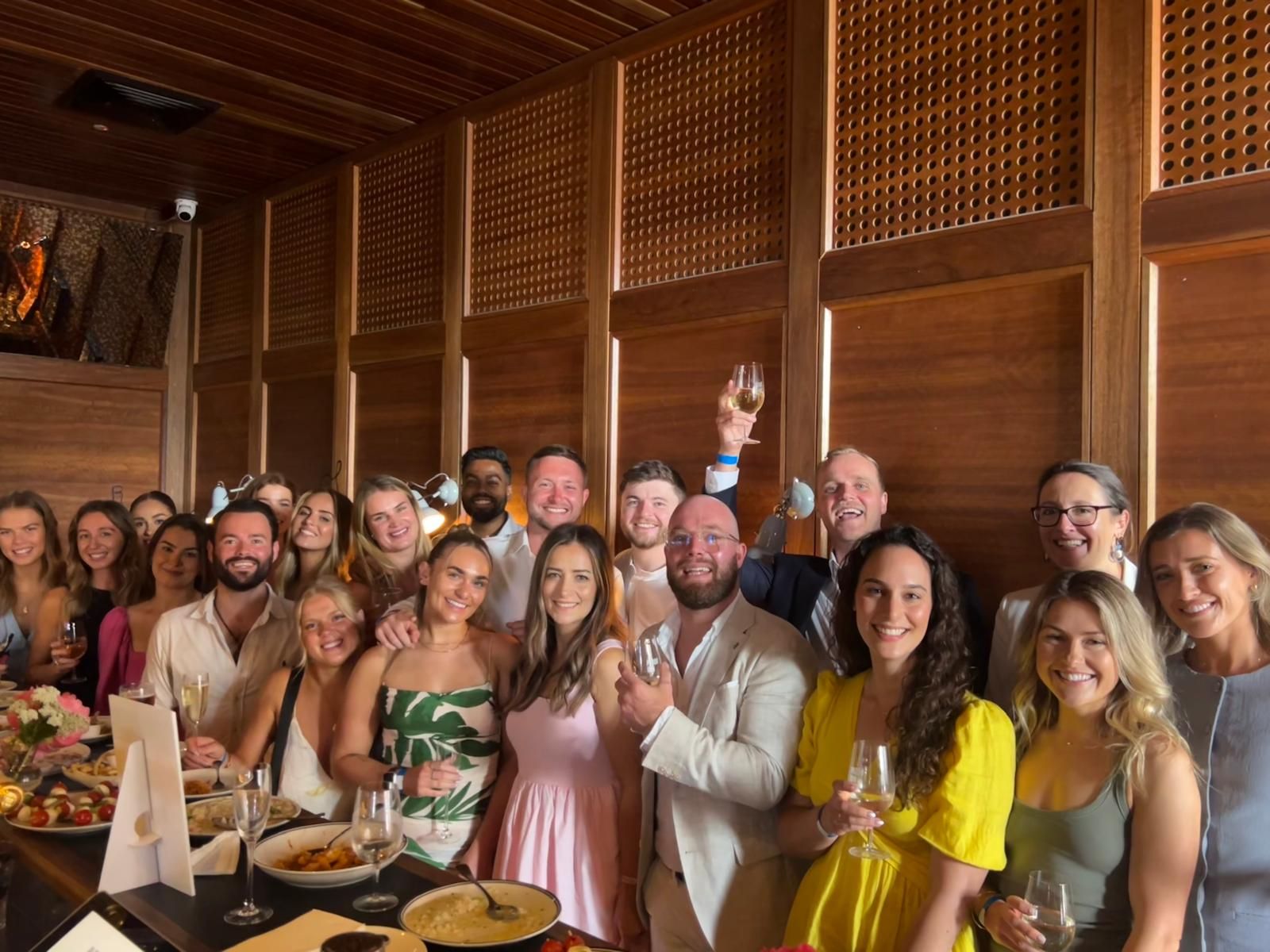 A group of people are posing for a picture in a restaurant.