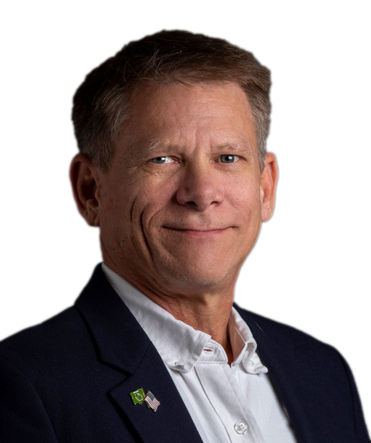 A man in a suit and tie is smiling for the camera