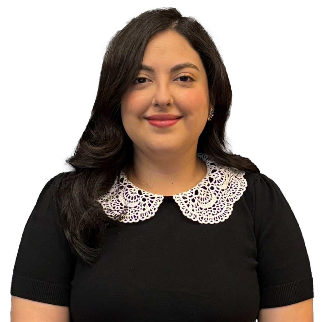 A woman wearing a black shirt and a necklace is smiling.