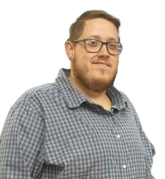 A man wearing glasses and a plaid shirt is standing in front of a white background.