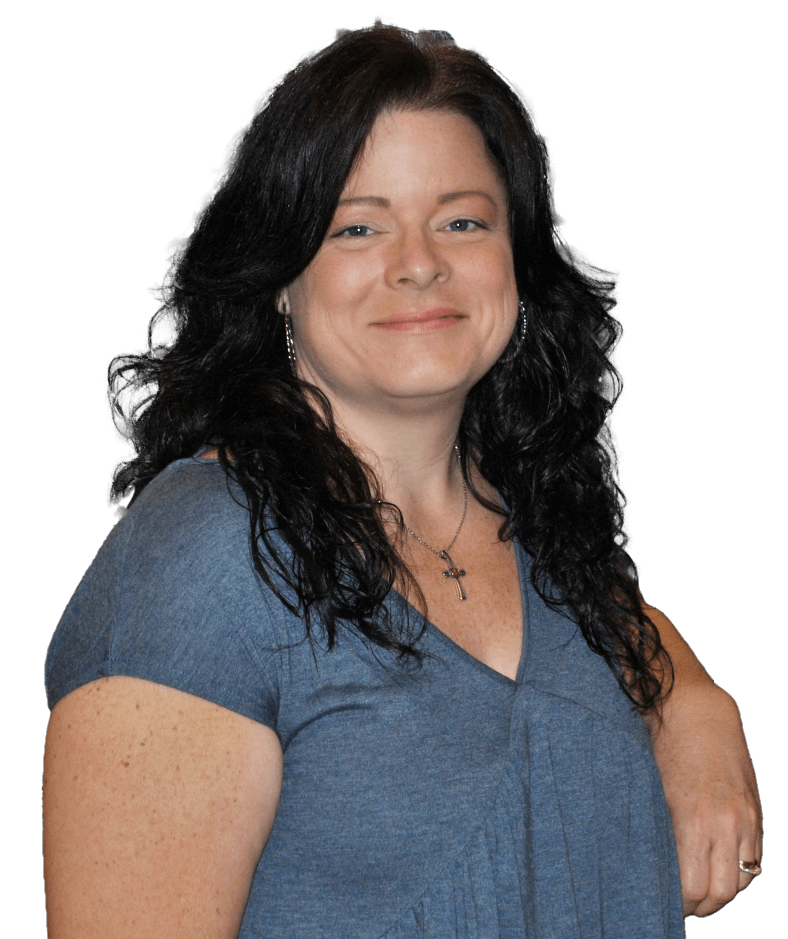 A woman in a blue shirt is smiling for the camera