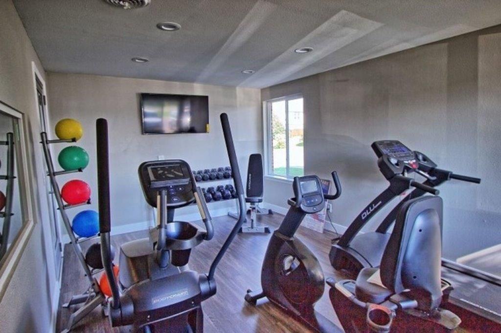 gym photo showing eliptical, cycling and treadmill machines