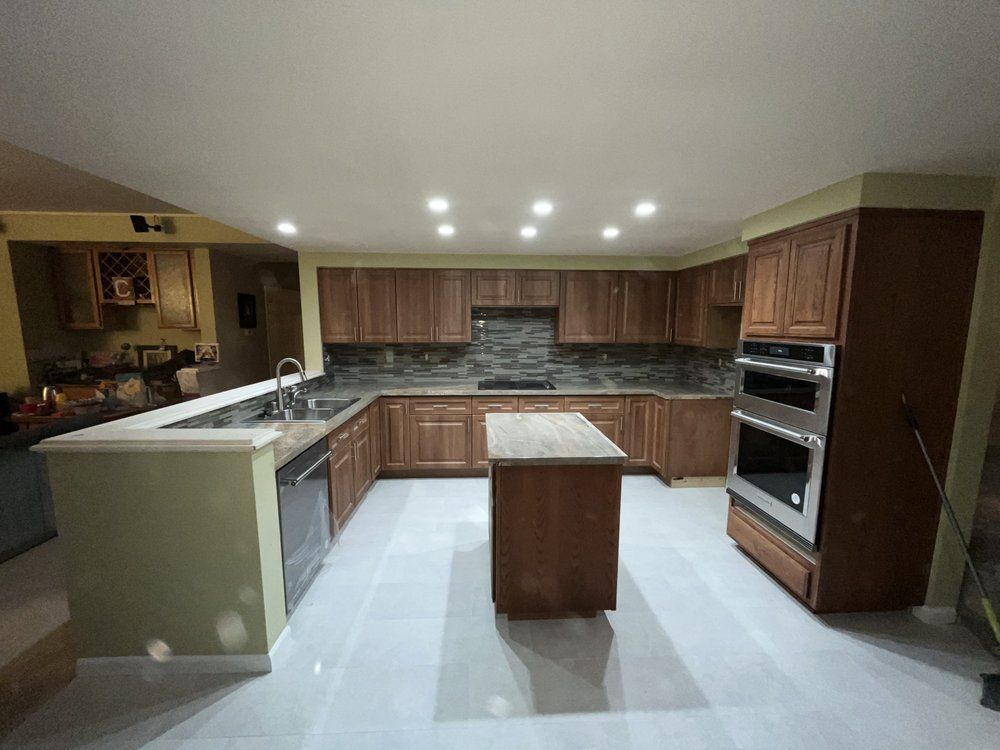 A kitchen with stainless steel appliances and wooden cabinets