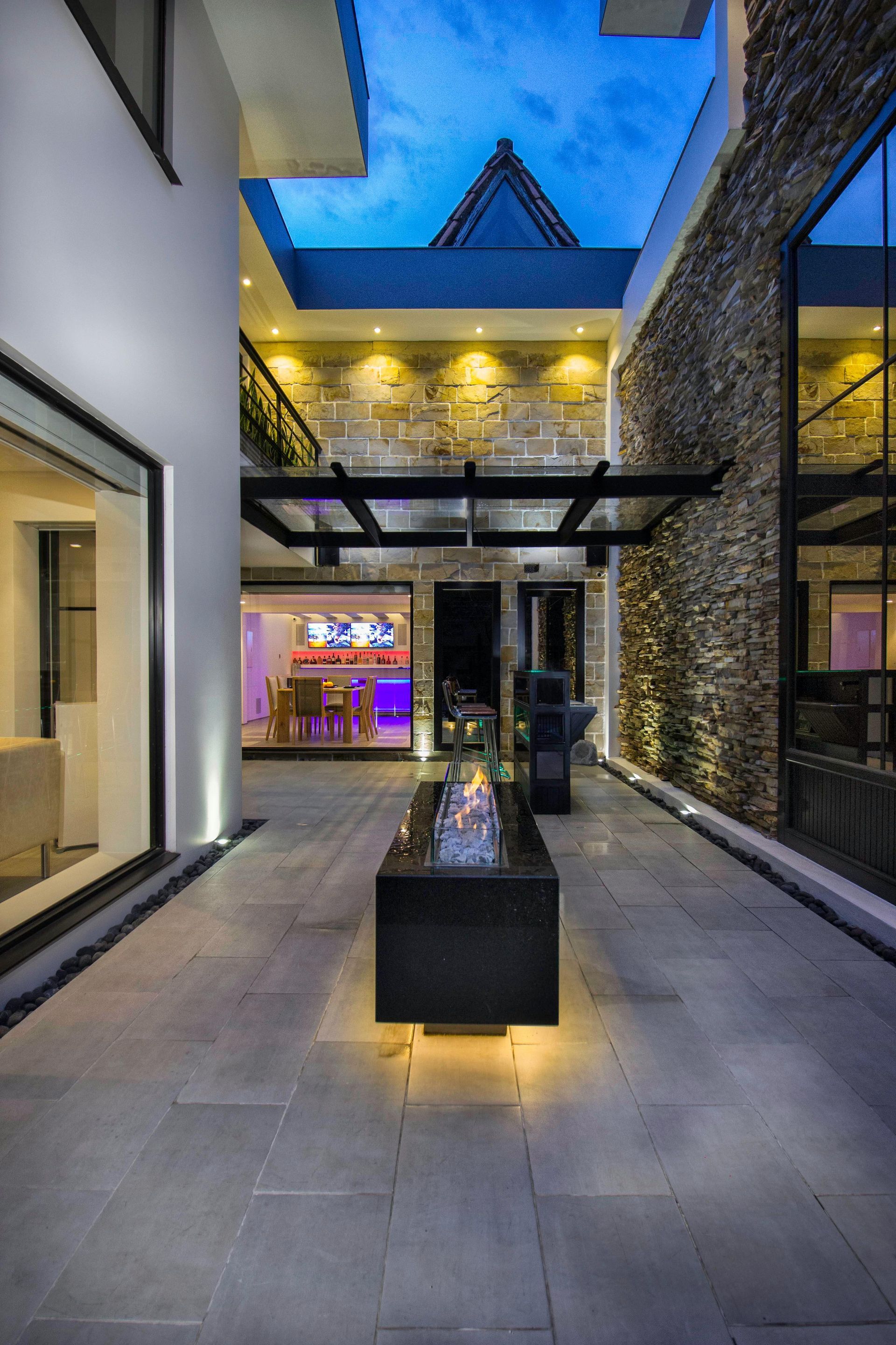 Lawn with freshly cut grass, autumn trees with colorful leaves, and a clear sky.