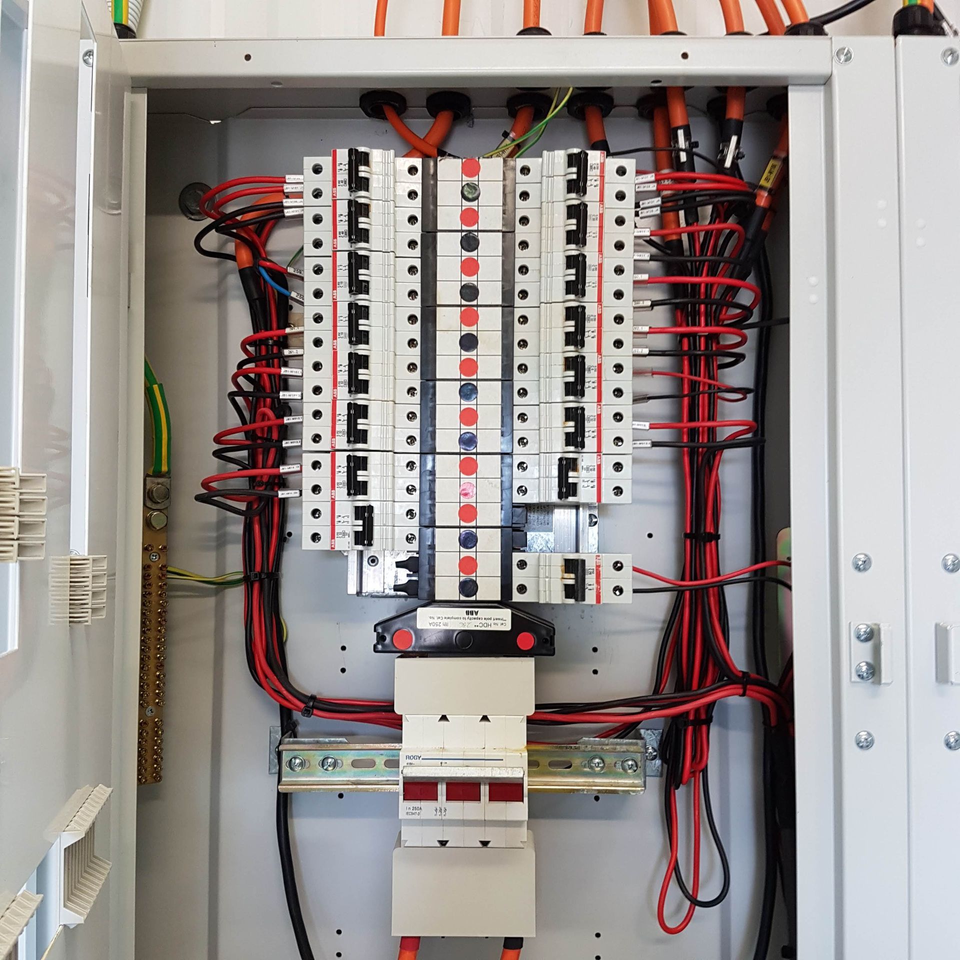 A very large electrical box with lots of wires coming out of it