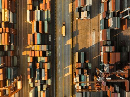 An aerial view of a warehouse filled with lots of shipping containers.
