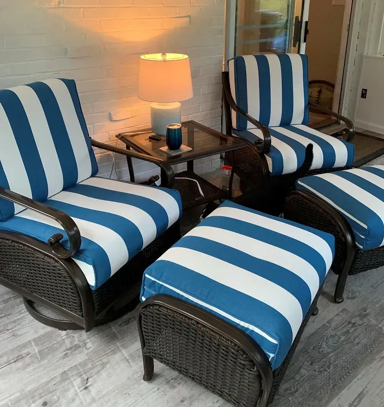 Blue and white striped chairs and ottomans in a living room