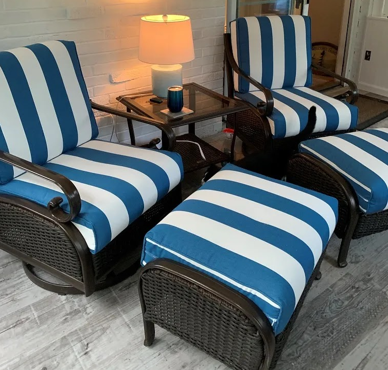 Blue and white striped chairs and ottomans on a patio