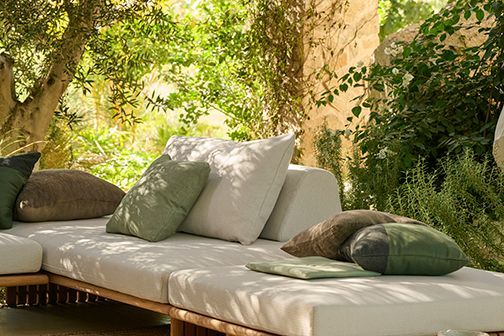 A patio with a lot of furniture and a potted plant.