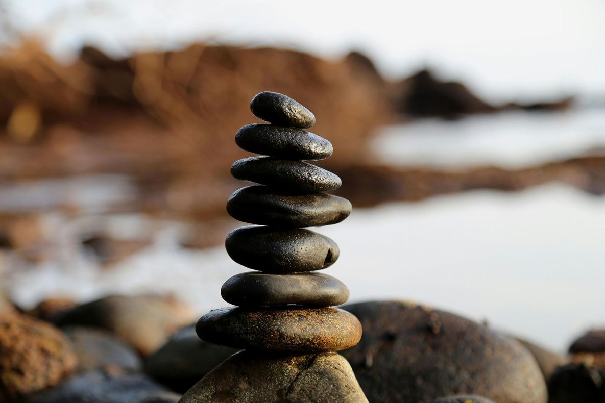 A pile of rocks stacked on top of each other on a beach
