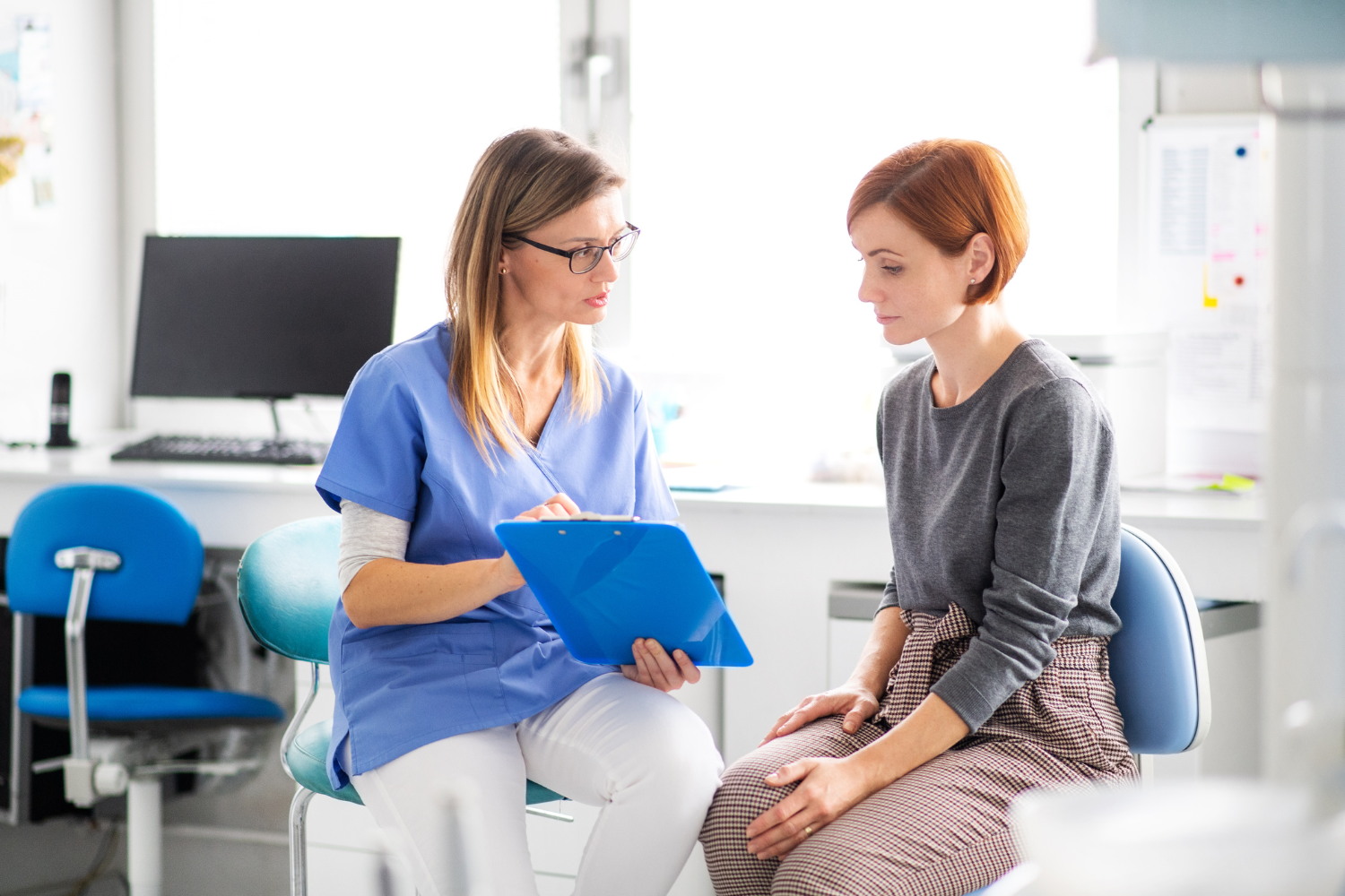 women sitting with dental assistant