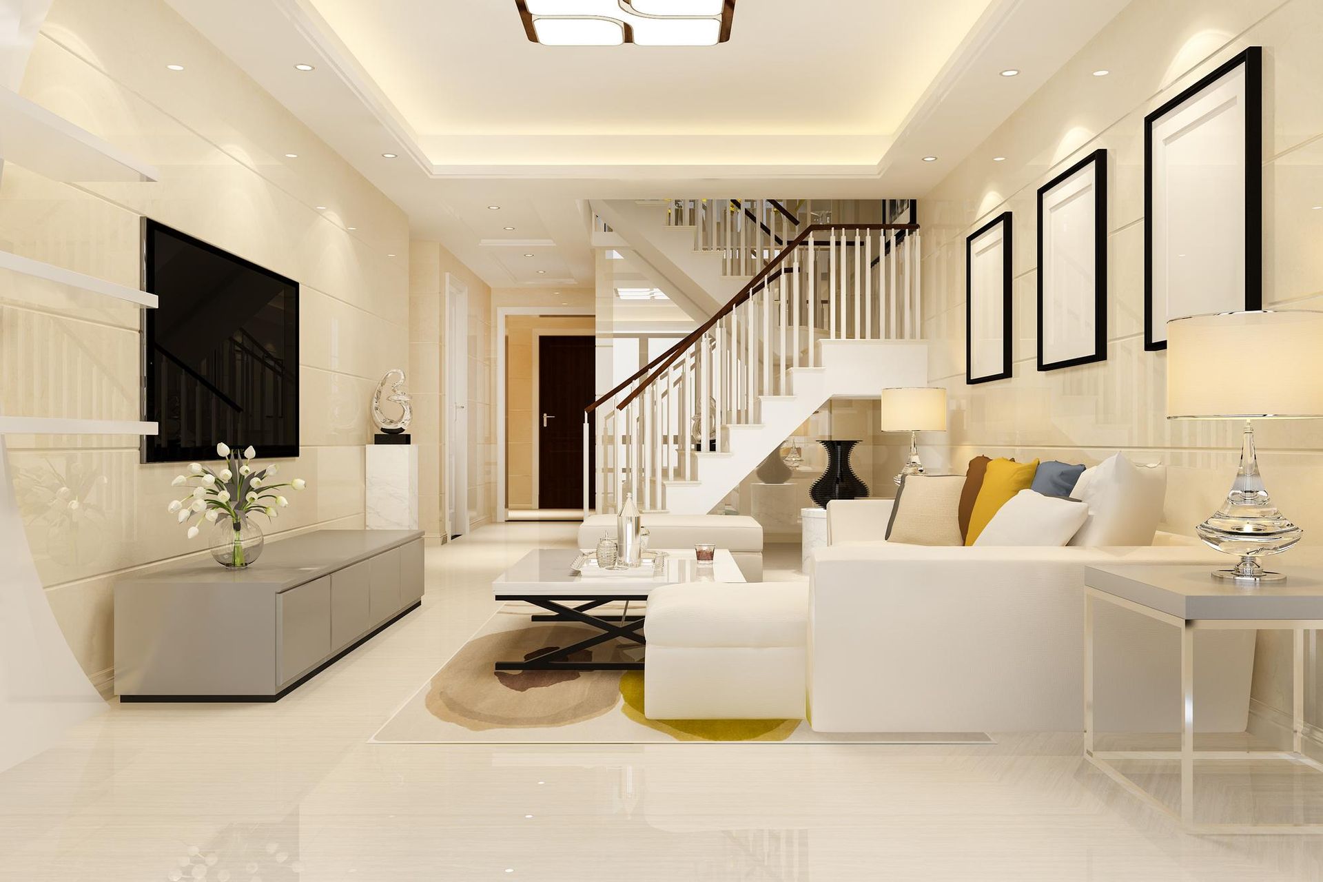 Living room with white furniture, staircase, TV, and framed art.