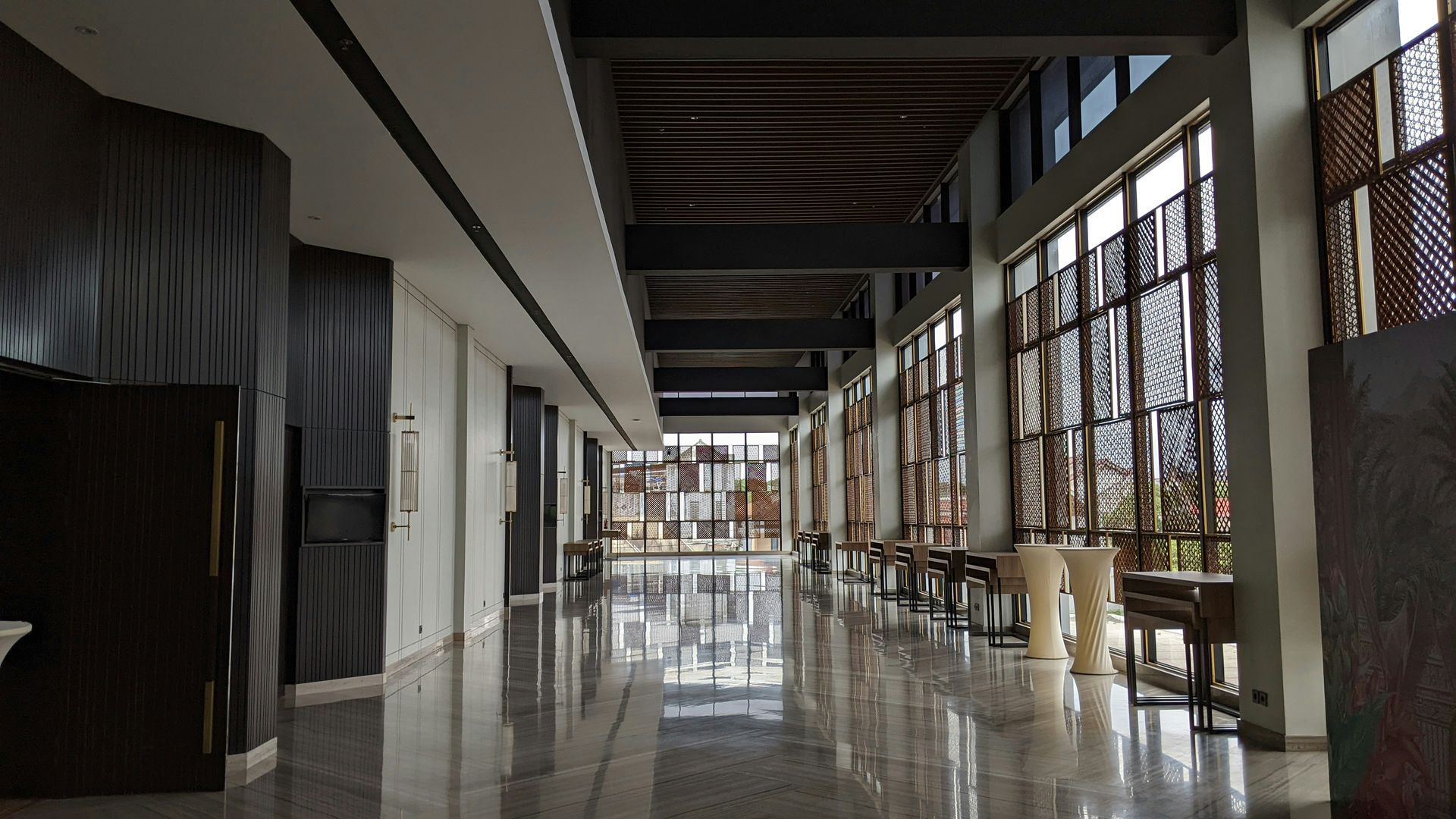 Wooden church pews in a dimly lit room, with a beam of light shining across them.