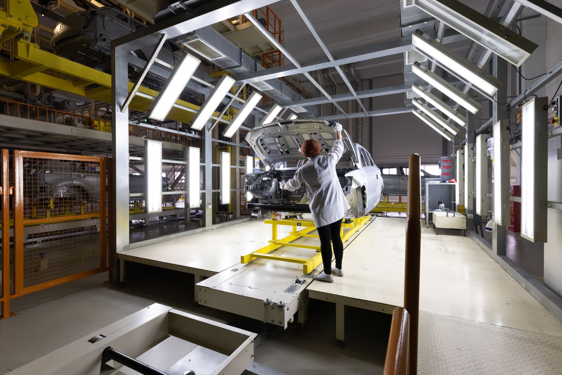Clean, white-walled doctor's examination room with a medical bed and built-in counter.