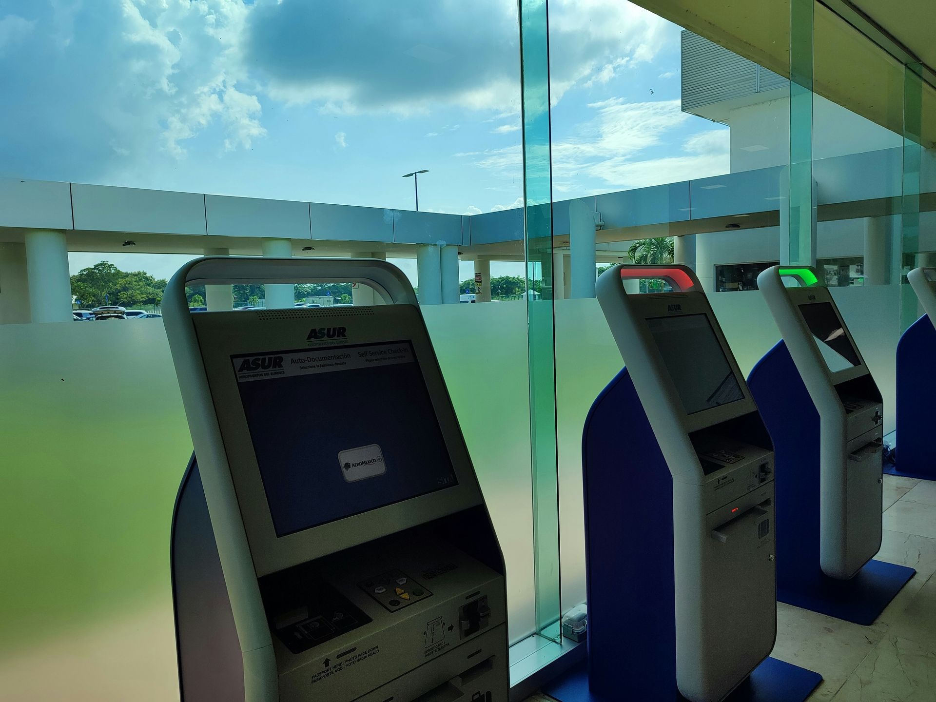 Man repairing ATM in a Nampa bank, with the machine's interior exposed. Red ATM signage is visible.