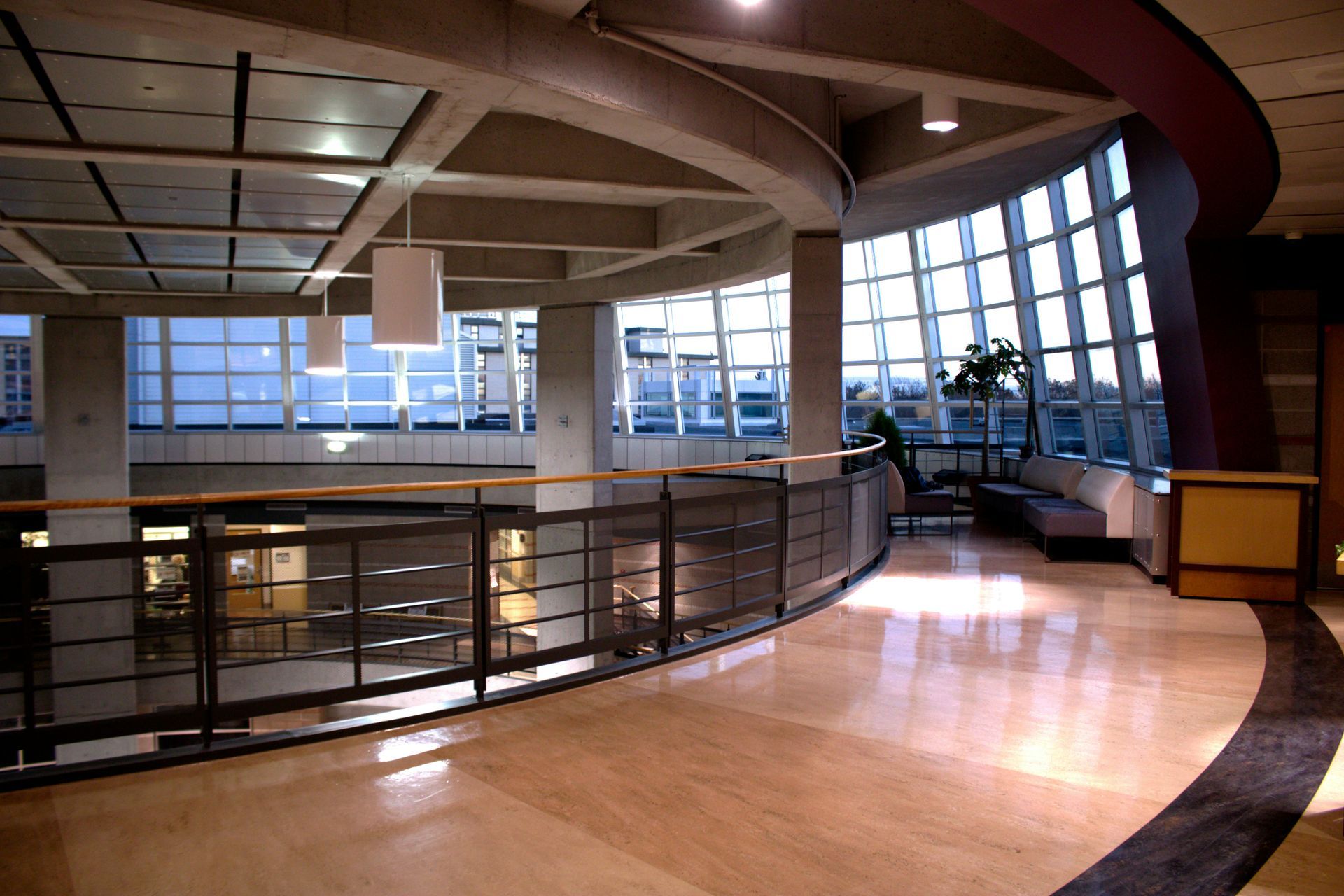 Wooden church pews in a dimly lit room, with a beam of light shining across them.